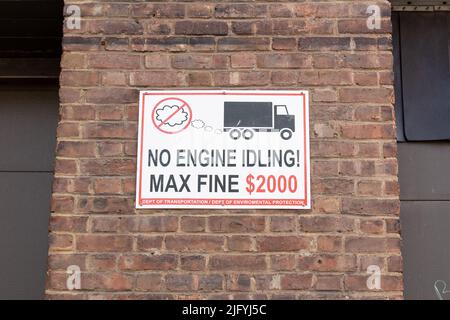 A No Engine Idling Sign on a brick wall to reduce pollution