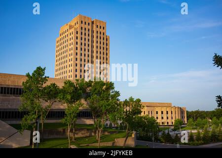 The North Dakota State Capitol, pictured here from the Capitol Grounds Native Prairie at Bismarck, is a 21-story Art Deco tower that is the tallest ha Stock Photo