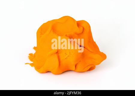 Orange colorful play dough for kids on white background. Children creativity and modeling clay Stock Photo