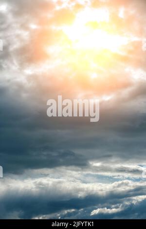 Thunderclouds with breaking rays sun at sunset Stock Photo