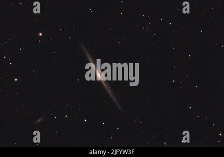 Needle galaxy in the constellation of Coma Berenice, a edge-on spiral galaxy near the Galactic North Pole. Star map and night sky background Stock Photo