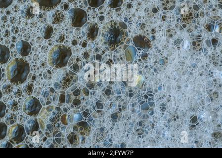 White foam with soap bubbles of different size and shape, structure in the foreground. Flat lay top view Stock Photo