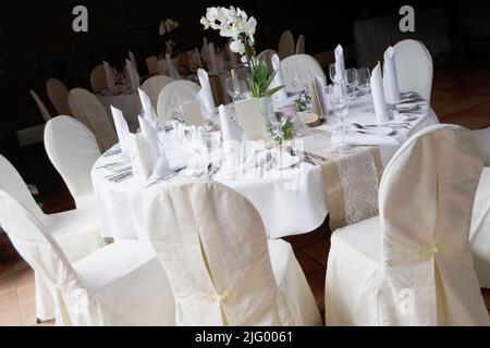 Laid table with wine glasses, plates, cutlery etc. Stock Photo