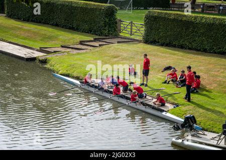 young male boy Pupils from teachers of the Magdalen College School Oxford having rowing sculling scull boat lessons on the banks of the river Cherwell Stock Photo