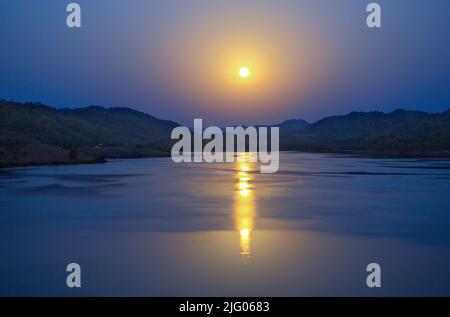 Panoramic view of river Narmada with reflection of full moon  and mountains on both sides  of irrigation canal in Gujarat ,India,Asia Stock Photo