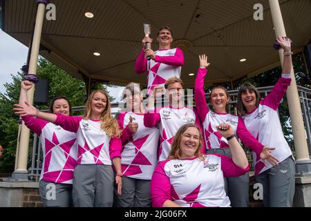Windsor, Berkshire, UK. 6th July, 2022. The Birmingham 2022 Queen's Baton Relay holders next to the Bandstand in Alexandra Gardens in Windsor today. The next stop for the relay is the Isle of Wight. Credit: Maureen McLean/Alamy Live News Stock Photo