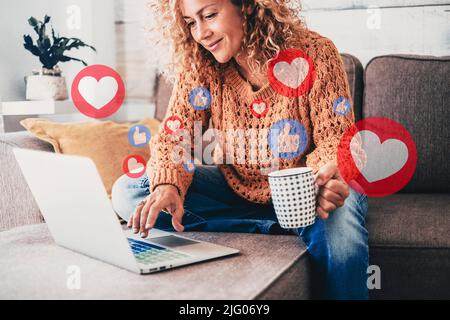 Young woman using laptop sitting on the sofa at home. Alternative workplace with computer, Modern people in smart working activity, Leisure indoor sur Stock Photo