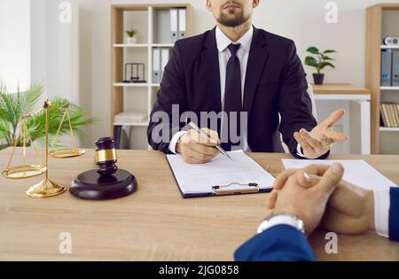 Lawyer, notary or judge consults and discusses contract documents with business client in office. Stock Photo