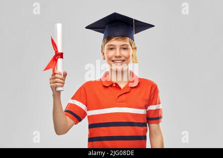 graduate student boy in mortarboard with diploma Stock Photo