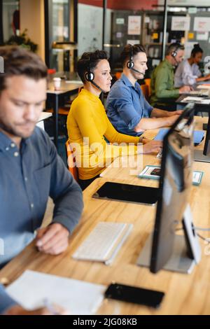 Confident caucasian female customer service executive working on computer in office Stock Photo