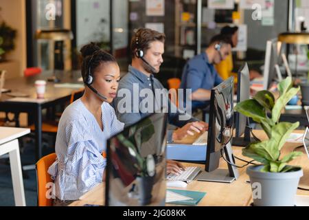 African american female customer service executive working with colleagues in office Stock Photo
