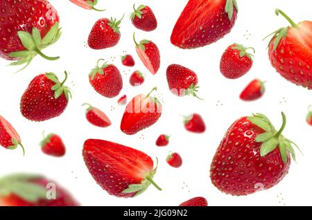 Strawberry levitation on a white isolated background. Whole pieces of strawberries and cut Stock Photo