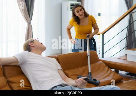 Man husband cleaning the house helping wife Stock Photo - Alamy