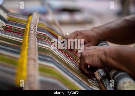 Ecuador, Quito, Paguche. Tahuantinsuyo Weaving Workshop. Traditional "back strap" weaving demonstration. Hand close up. Stock Photo