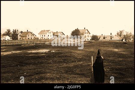 An early photograph of Gallows Hill, Salem, USA with a woman in witches clothing in the foreground. Gallows hill was long believed to be the site of the execution of witches during the Salem witch trial hysteria, however the Gallows Hill Project confirmed the belief  that Proctor’s Ledge, a small hill located between Proctor Street and Pope Street in Salem was the actual site,  in January  2016. The Salem witch trials ( hearings and prosecutions of people accused of witchcraft) took place between February 1692 and May 1693. More than two hundred people were accused. 30 were found guilty. Stock Photo