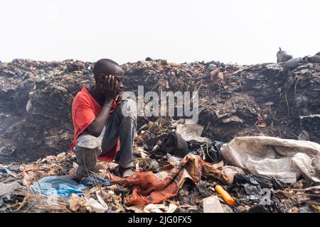 Poor boy collecting garbage in his sack to earn his livelihood