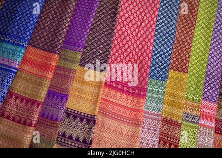 Thai traditional fabric from Lamphun displayed on a seller stall at the Chiang Mai Sunday market. Stock Photo