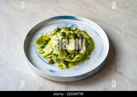 Salad Zucchini Slices with Pesto Sauce, Mint Leaves and Olive Oil. Ready to Eat. Stock Photo