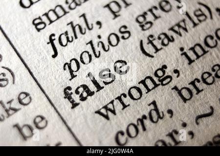 Definition of word false on dictionary page, close-up Stock Photo