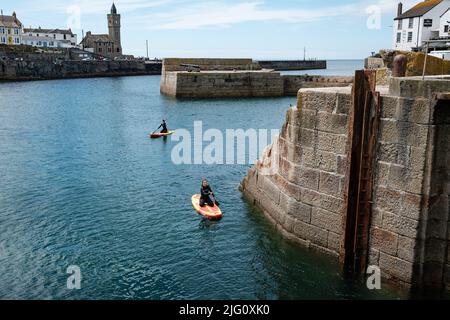 Paddleboarding in Porthleven harbour, Cornwall Stock Photo