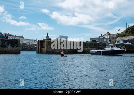 Paddleboarding in Porthleven harbour, Cornwall Stock Photo