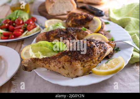 Crispy chicken legs with salad and bread Stock Photo