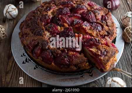 Upside down cake with plums and cinnamon for christmas season Stock Photo