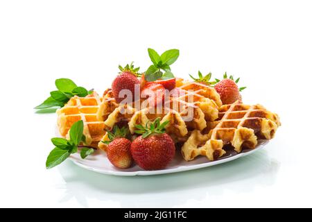 Sweet curd cooked waffles with fresh ripe strawberries, isolated on white background Stock Photo