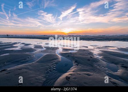 Beautiful sunset on the horizon over the North Sea as seen from the Dutch coast in northwesterly direction Stock Photo