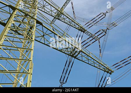 Power pole with insulators and high-voltage cable Stock Photo