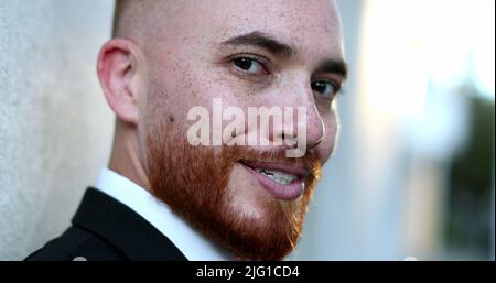 Portrait man smiling to camera outside, handsome viking looking guy redhead Stock Photo