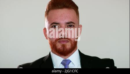 Portrait redhead man wearing business suit looking at camera, no emotion, photo portrait close-up Stock Photo