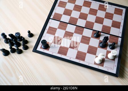 The chess. Checkmate position on the board game in a view from the top angle. The game board is on the table. Stock Photo