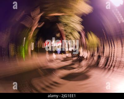 Motion blur city and futuristic car in motion. Abstract defocused blured road with car on high speed. Stock Photo