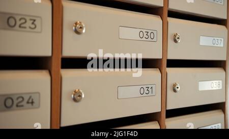 Corridor with postboxes on walls in new residential building. Stock footage. View inside of the entrance of an apartment house with mailboxes Stock Photo