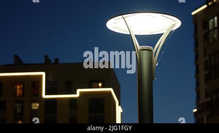 Close up city courtyard with street lamp on a dark blue sky background. Stock footage. Late evening landscape outdoors with an apartment building Stock Photo