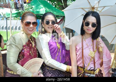 Thai women in national historical costumes pose for a photo. Stock Photo
