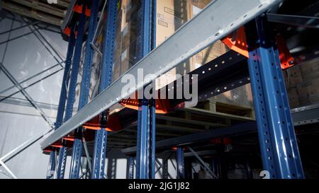 Moscow - Russia, 04.20.2022: Warehouse materials and metal shelves with goods inside cardbox boxes. Creative. The camera moves among the shelves with Stock Photo