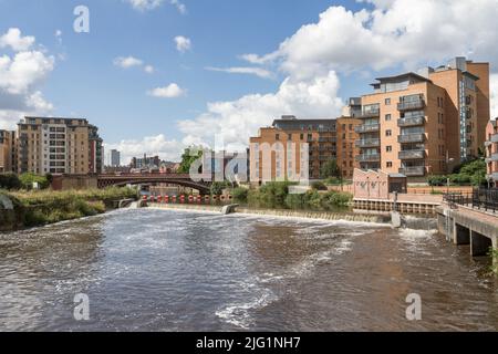 Weir on the River Aire looking towards Crown Point bridge in Leeds, West Yorkshire, UK. Stock Photo
