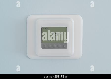 Modern residential programmable heating and cooling thermostat Stock Photo