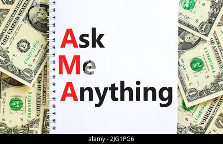 AMA ask me anything symbol. Concept words AMA ask me anything on white note on a beautiful background from dollar bills. Business and AMA ask me anyth Stock Photo
