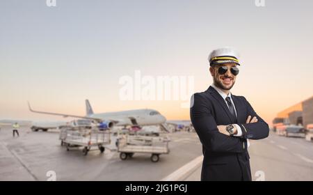 Pilot smiling and posing on an airport apron Stock Photo