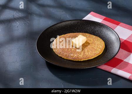 Typical food in Colombia - tasty arepa de choclo with butter. Stock Photo