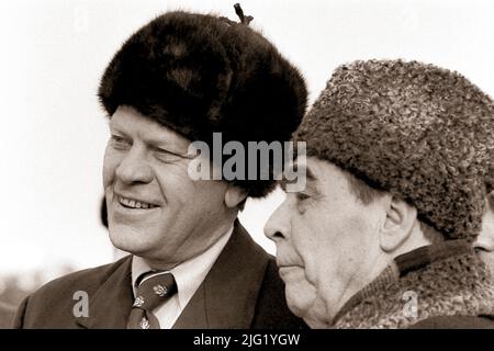 President Ford dons a Russian wool cap upon his arrival in Soviet Union, shown here with Soviet General Secretary Leonid Brezhnev at Vozdvizhenka Airport, Vladivostok, USSR.  November 23, 1974. Stock Photo