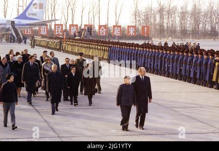 Escorted by Deng Xiao Ping President Ford inspects the honor guard upon his arrival in China with his entourage, which included Mrs. Ford and Secretary of State Henry Kissinger. December 1, 1975. Stock Photo