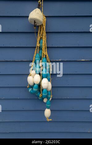 Net floats hanging on a wall at Petty Harbour Stock Photo
