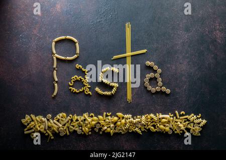 The word Pasta made from pasta noodles, against a dark background. Stock Photo