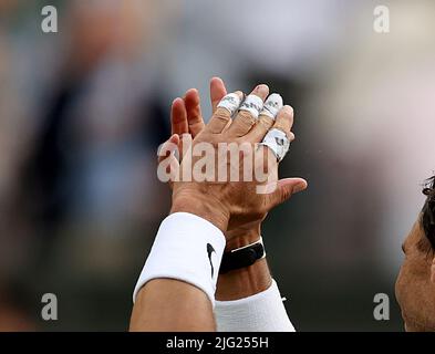 London, UK. 6th July, 2022. Photo taken on July 6, 2022 shows a detailed view of bandages on the fingers of Rafael Nadal of Spain as he celebrates after winning the men's singles quarter-final match against Taylor Fritz of the United States at Wimbledon Tennis Championship in London, Britain. Credit: Li Ying/Xinhua/Alamy Live News Stock Photo