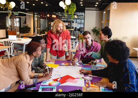 Multiracial design professionals discussing ideas during meeting in creative office Stock Photo