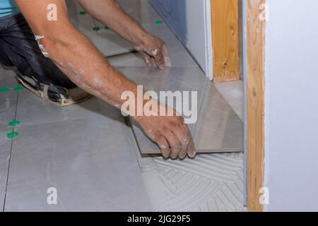 Tile installation on adhesive surfaces during home construction Stock Photo